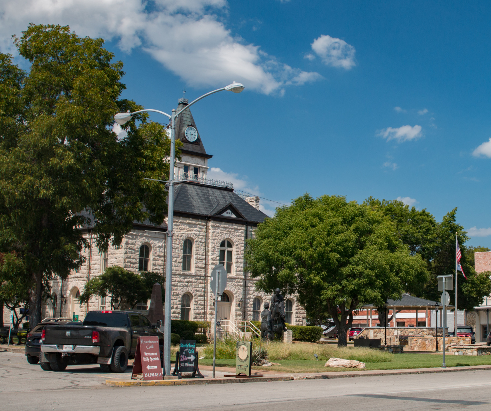 Downtown Glen Rose, Texas, with a few buildings and cars.